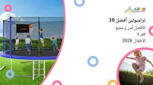 أطفال يلعبون كرة السلة على الترامبولين محاط بشبك أمان، وسط منظر طبيعي أخضر وتحت سماء زرقاء.